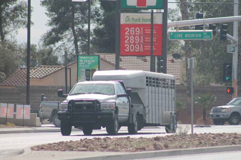 Silver third-generation Ram 2500 towing a horse trailer on a city street